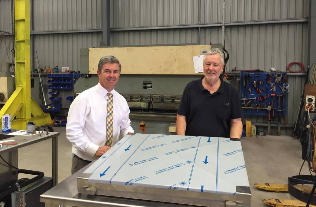 Lyne MP, Dr David Gillespie with Rob Eddy from Food Machines Australia in Production Drive in Wauchope with one of the sophisticated commercial food processing machines destined for America.