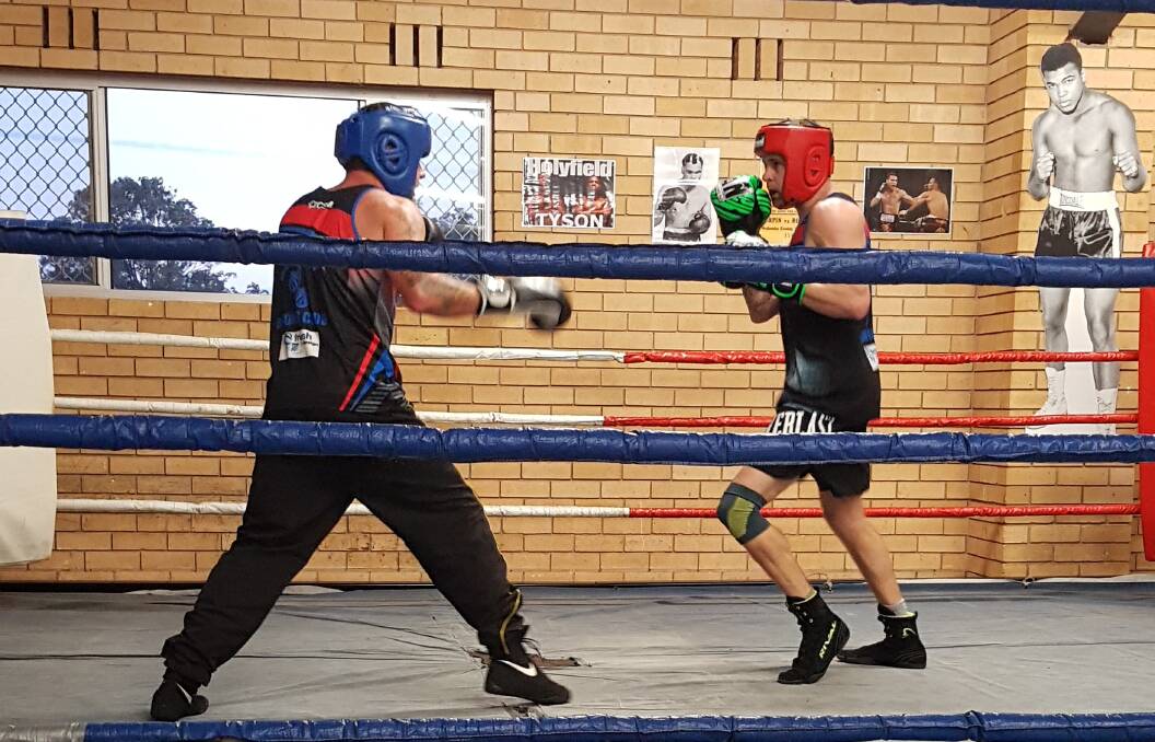 AT THE READY: Elijah Matikainen (left) and Beau Dark sparring in preparation for fight night.
