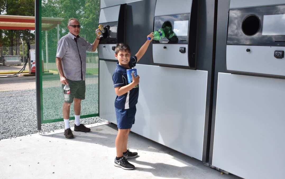 RETURN AND EARN: Graeme Cook and grandson Noah Langdon were among the first to put the new reverse vending machine to the test.