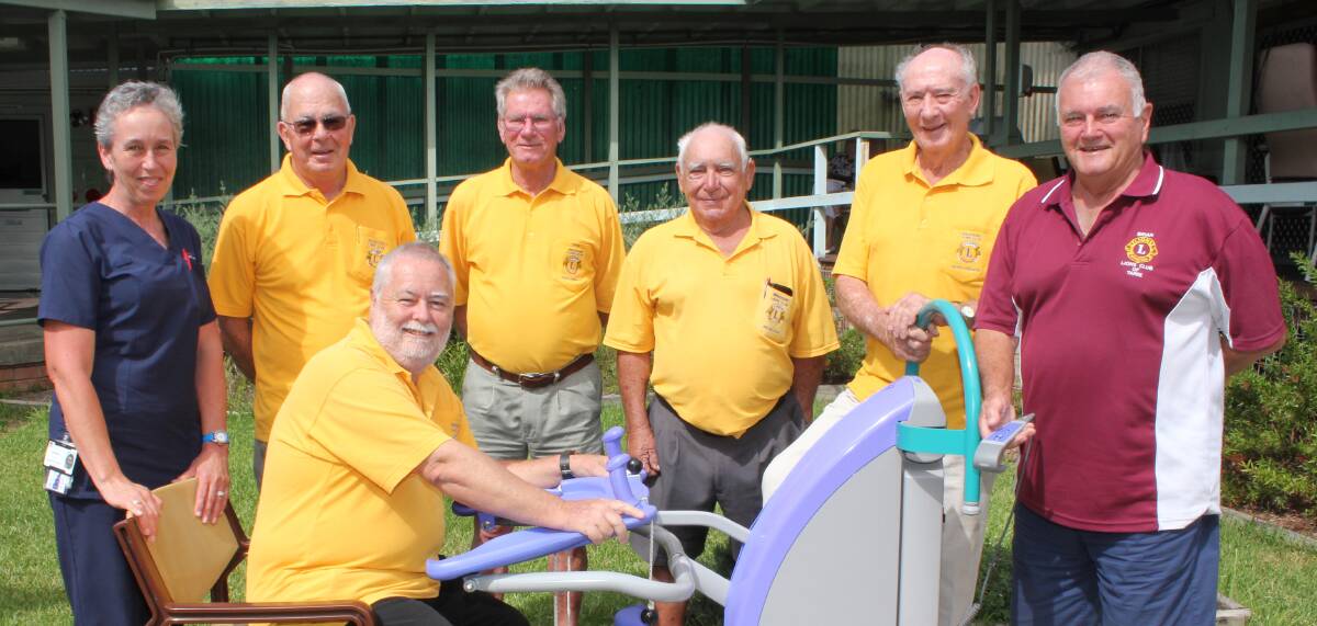 HOW IT'S DONE: Registered nurse Denise Holz shows Wauchope Lions the specialised lifting chair donated as part of a $13,500 gift to Wauchope Hospital. Pictured with Ms Holz are (front) Lions President Gordon Douglass and (back) Lions Jim Munro, Bob Jones, Jim Callega, Bruce Cant and Lions District representative Brian McWhirter.