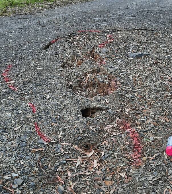 The cleft/split in the road as pictured indicates that structural damage has occurred but detailed survey and engineering work is required to assess and resolve the issues.