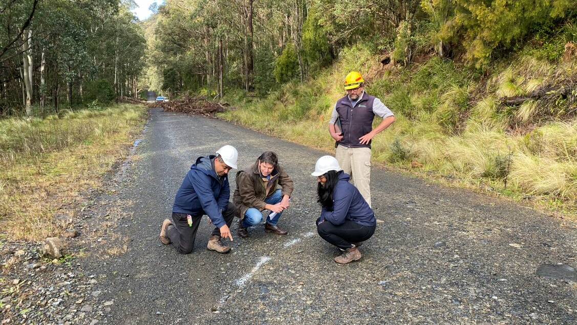 Geotrack engineer consultant Roy Einarsen shows Dave Layzell the damage on Barrington Tops Forest Road with engineer consultant Sarah Einarsen and Forestry Corp representative Mick Wilson watching on. Photo supplied
