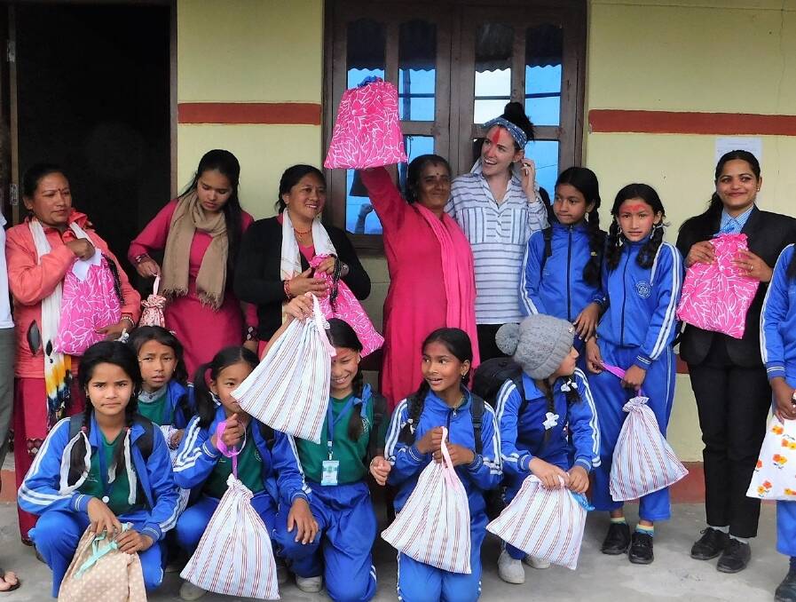 Nepalese school girls and their female teachers with their very own reusbale santiary product packs. Photo supplied