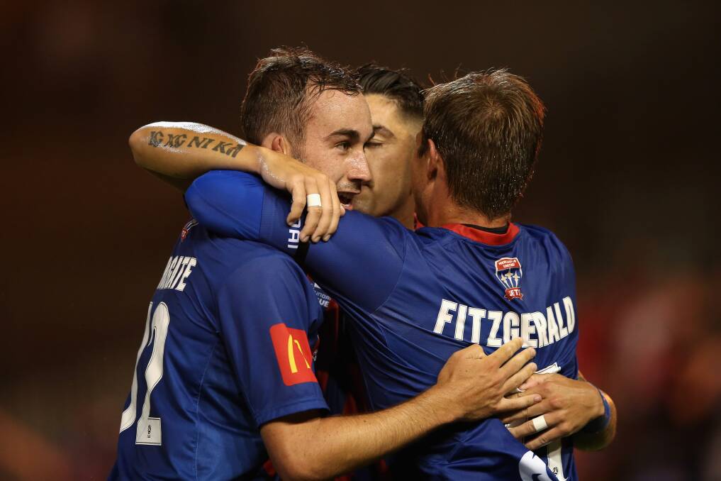MATCH-WINNER: Angus Thurgate is congratulated by Nick Fitzgerald and Dimi Petratos after scoring a goal in the Jets' 2-0 triumph over Western Sydney at McDonald Jones Stadium on Saturday night. Picture: Getty Images