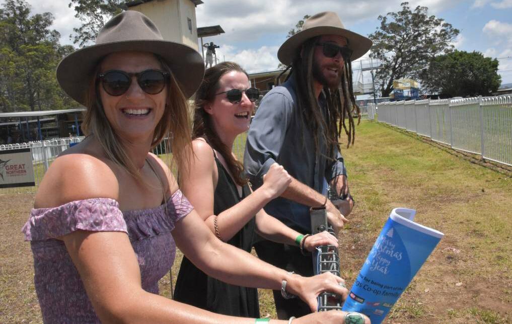 ON THE FENCE: Amy Riddle, Pauline Caillot and Ben Lawrie having a blast at the races in 2019.