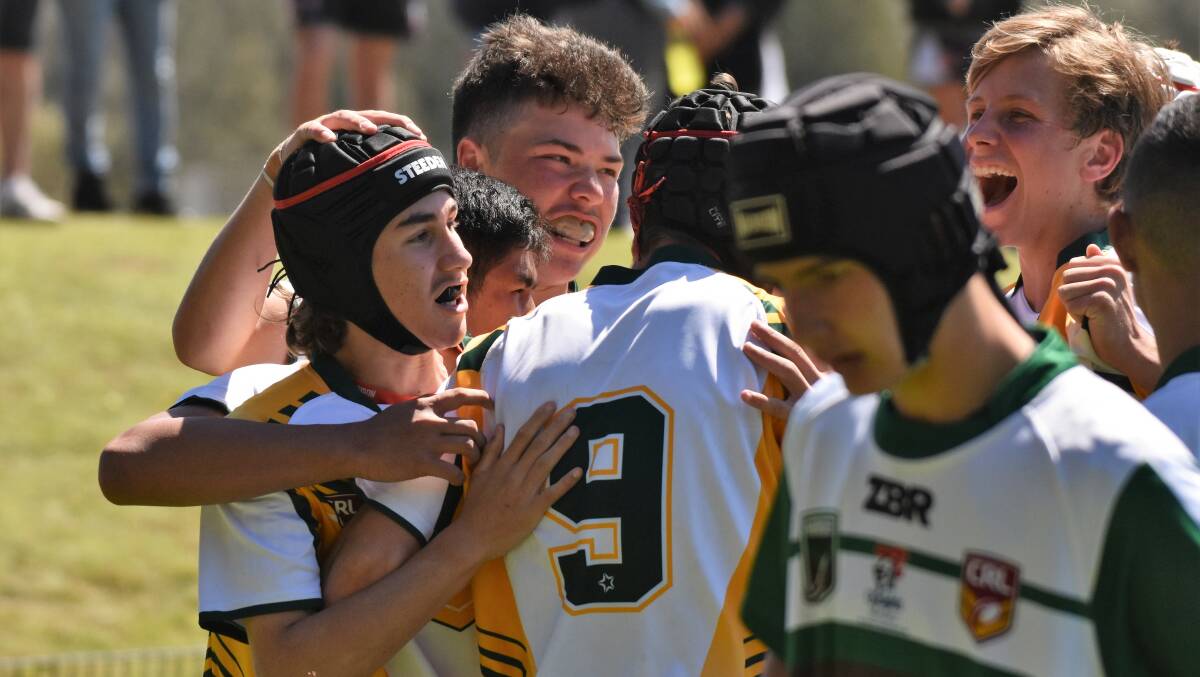 Back again: Group 3 players celebrate a try at last year's Country Championships in Port Macquarie.