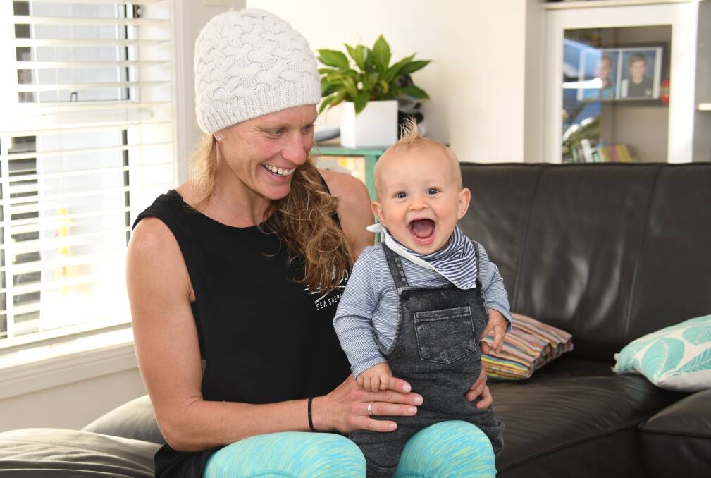 Mum's the word: Triathlete Caroline Steffen with eight-month-old son Xander in their Port Macquarie home. Photo: Matt Attard
