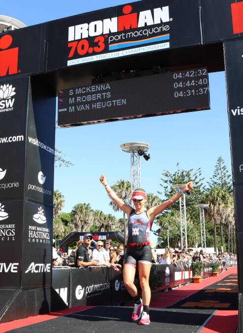 On track: Madi Roberts crosses the finish line in Ironman 70.3 Port Macquarie. Photo: supplied
