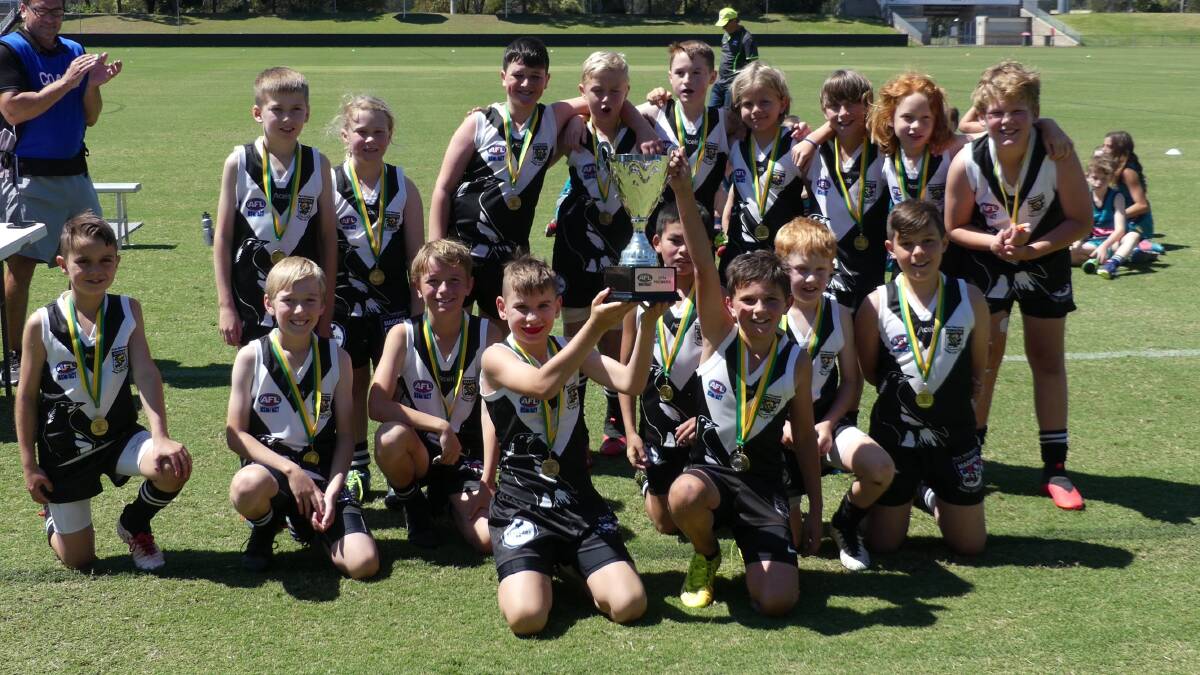 Winning feeling: Port Macquarie Magpies' under-11s with the premiership cup. Photo: supplied