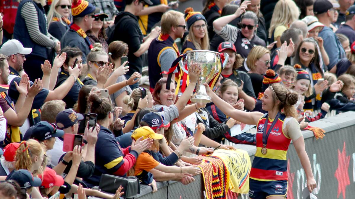Starting point: Adelaide Crows' Jenna McCormick celebrates with fans during the AFLW grand final. Photo: AAP/Kelly Barnes