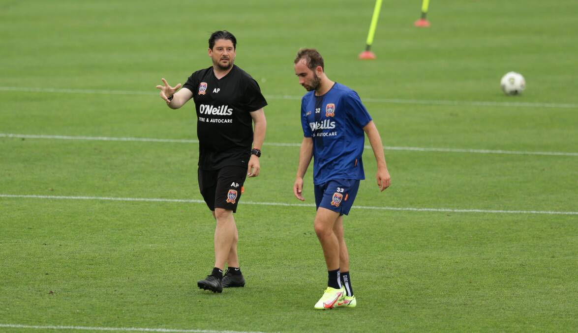 In discussion: Angus Thurgate (right) with coach Arthur Papas at training. Photo: Jonathan Carroll