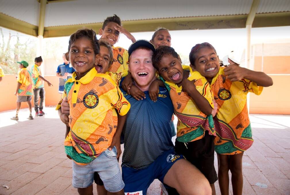 Great fun: Harry Hanley in the Northern Territory as part of the club's community visit. Photo: supplied