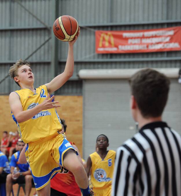 Lay it up: Zac Lawrence drives to the basket during the under-15 boys round-robin victory over Coffs Harbour. Photo: Ivan Sajko
