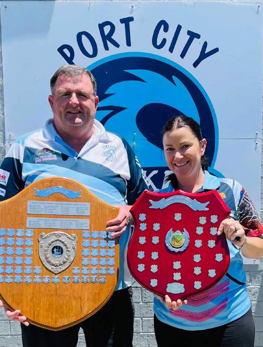 Port City senior president Geoff Kelly and junior president Cassie Smith with the club championship trophies. Picture supplied by Port City Breakers