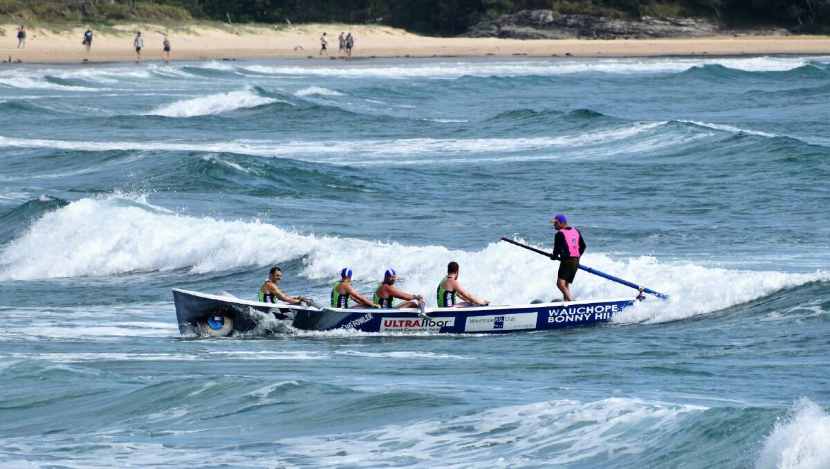 On the charge: Wauchope-Bonny Hills' under-23 men's surfboat crew. Photo: supplied/Phil Kaufmann