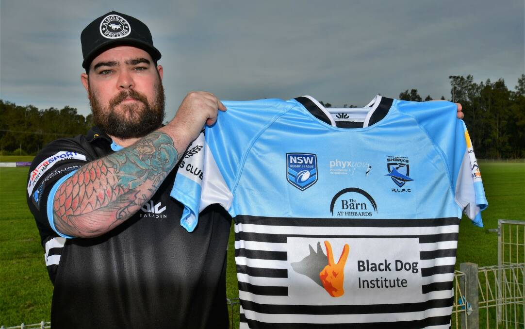 Zac Newcombe with the jersey the Sharks will wear against Wauchope on Saturday which will be auctioned off after the game. Photo: Paul Jobber
