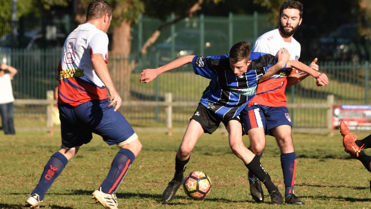 Challenging: Travis Pascoe battles for possession in Port Saints' 2-0 win over Wauchope on Saturday. Photo: Laura Telford