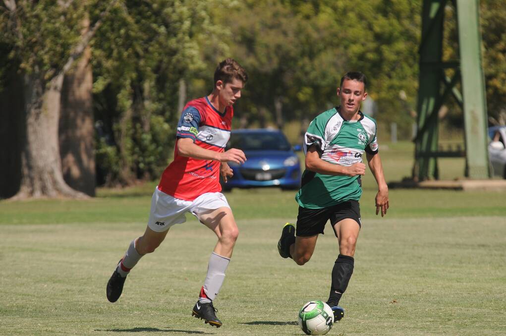 Hard work: Lachlan Walker tracks back in defence for Port United during their 4-2 win in Tamworth. photo: Samantha Newsam