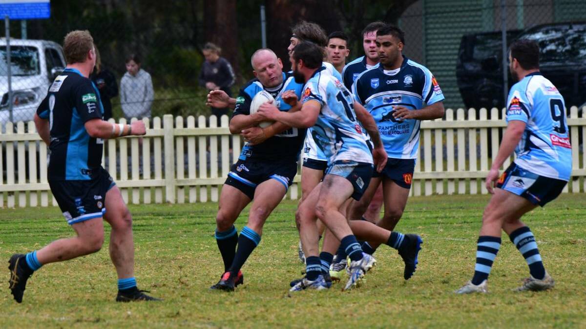 Carting it forward: Chris Piper takes the ball into the Breakers defence.