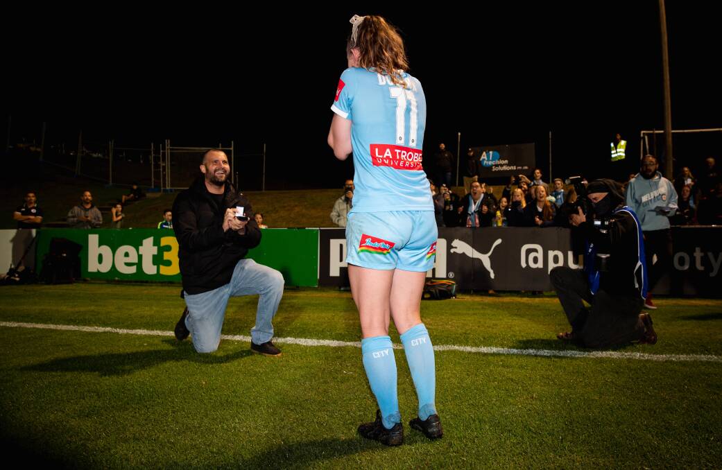 One one knee: The moment partner Matt Stonham proposed to Rhali Dobson. Photo: Melbourne City media.