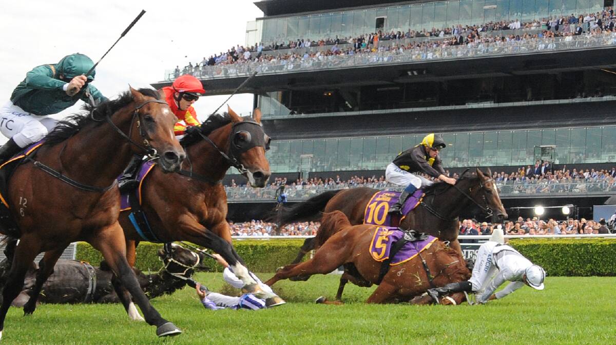 Jockey Mark Zahra rides Power Scheme to victory in race 1 as Andrew Adkins and Glyn Schofield take a fall at the finish line, during the Kings Of Sydney Sport Mile during The Championships Race Day at the Royal Randwick Racecourse in Sydney, Saturday, April 13, 2019. (Photo: AAP/Simon Bullard)