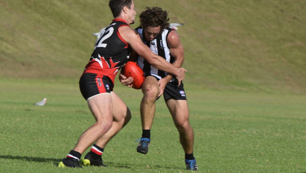 Come here: Lachy Philpott tries to bounce off his Sawtell defender on Saturday. Photo: supplied