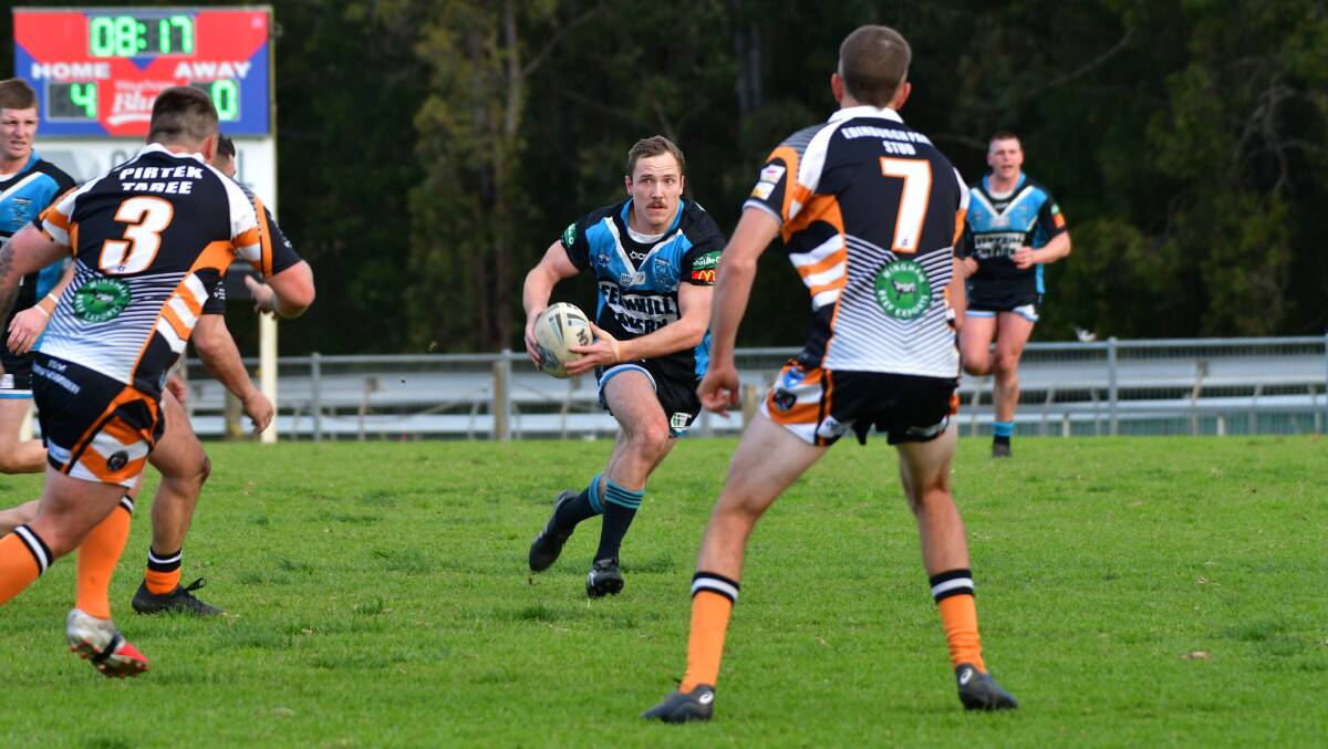 Port Sharks fullback Mitch Wilbow looks for a gap in the Wingham defence during their clash on July 17.