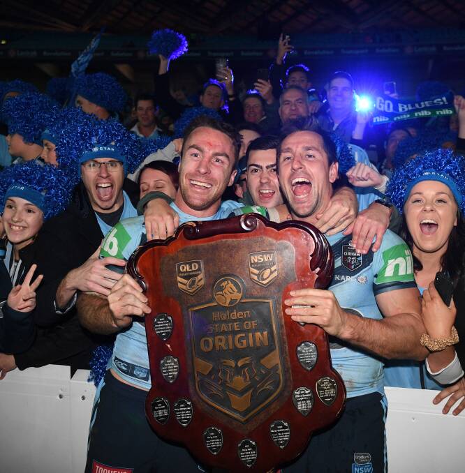 It's ours: James Maloney and Mitchell Pearce with the Origin shield. Photo: AAP Image/Dan Himbrechts.
