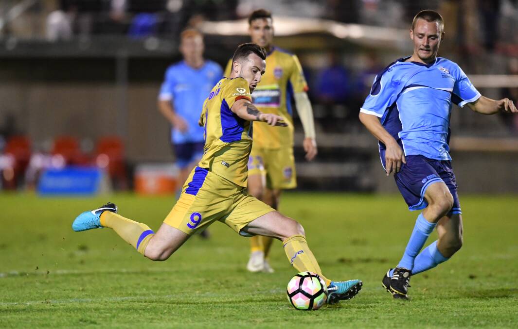 On target: Newcastle Jets striker Roy O'Donovan shoots for goal during Tuesday night's 9-0 win in Port Macquarie. Photo: Matt Attard