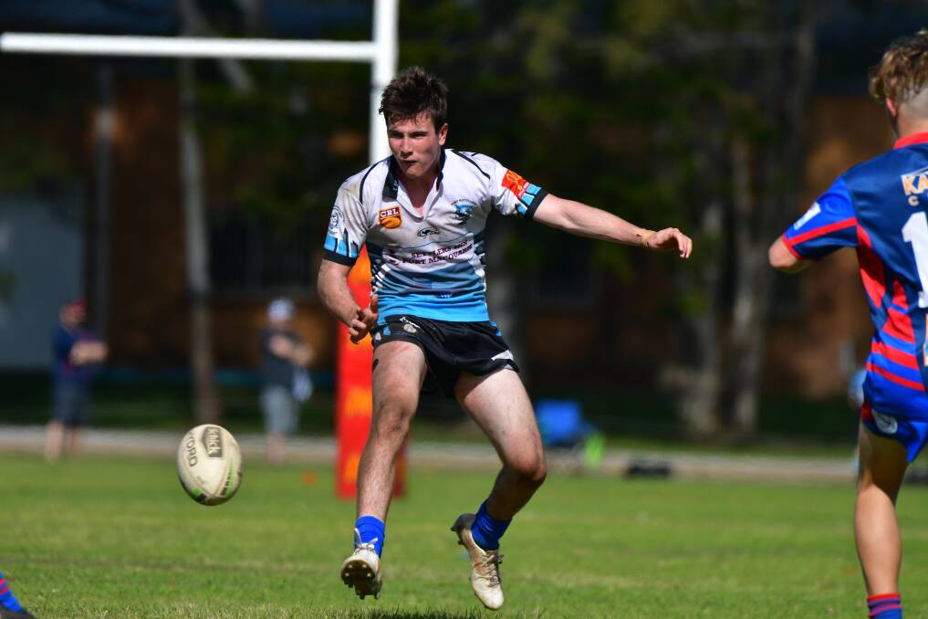 Made the cut: Port Macquarie Sharks halfback Joe Lewis puts boot to ball during the under-18 Group 3 rugby league season. Photo: Paul Jobber