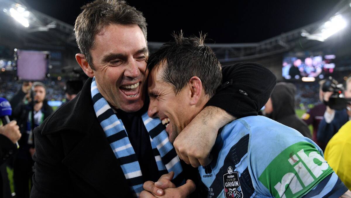 Winners: Brad Fittler and Mitchell Pearce embrace after the Blues win. Photo: AAP Image/Dan Himbrechts