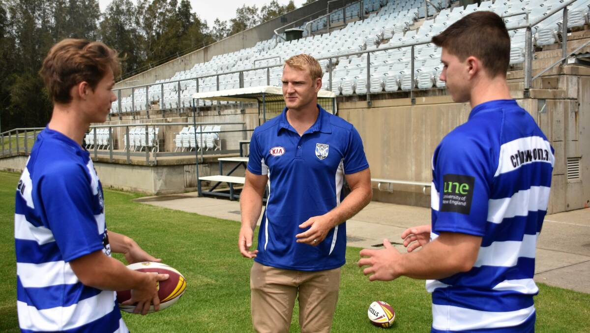 Pathway: Eli Clark, Aiden Tolman and Mitch Evans pass the footy around at Wednesday's announcement. Photo: Paul Jobber