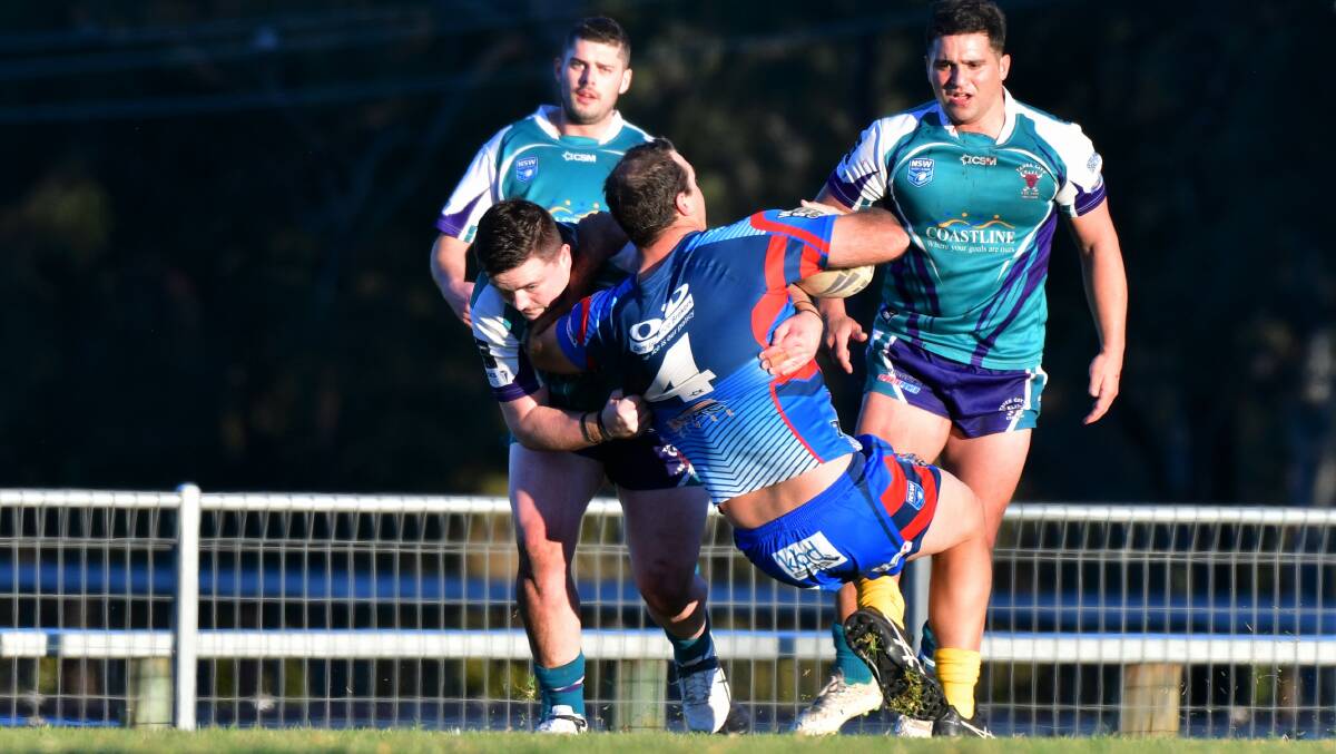 Down you go: Sam Watts is tackled in a match between Wauchope and Taree City this season.