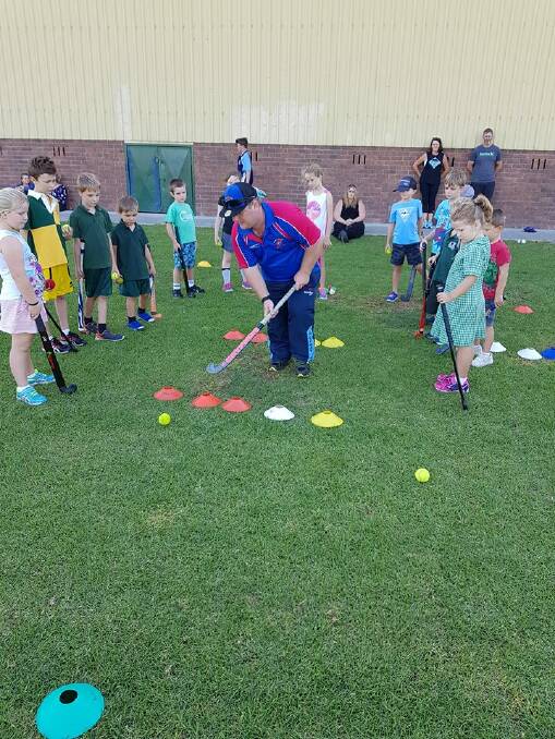 Teaching them: Coach Colin Pursehouse teaches the 4 to 7-year-old's stick skills. Photo: Supplied
