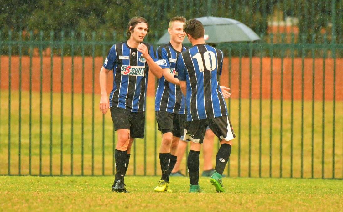 Job done: Michael Bishop (centre) converted from the spot in Port Saints' 1-0 victory over Alstonville FC.