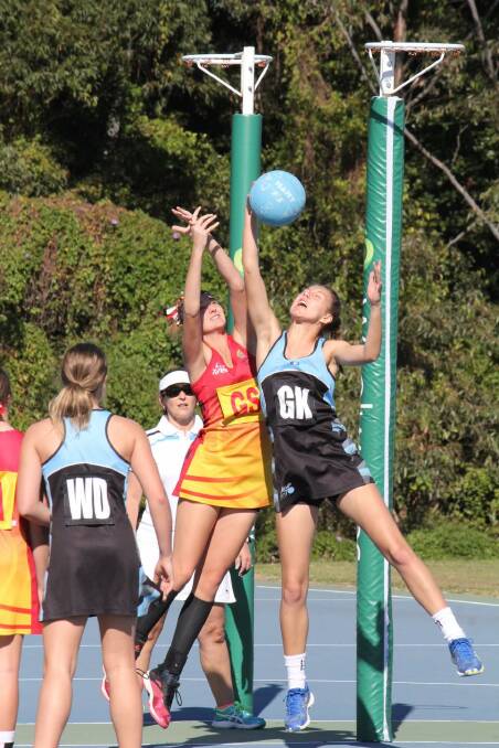 Get up there: Ella Smith wins the rebound in the 17's match against Manning Valley.