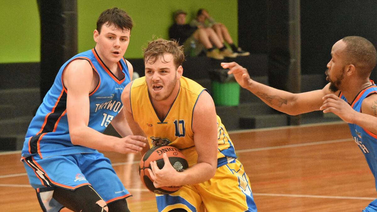 Leading the way: Port Macquarie Dolphins captain Jake Wallis drives towards the basket in their 111-57 loss to Tamworth on Sunday. Photo: Paul Jobber