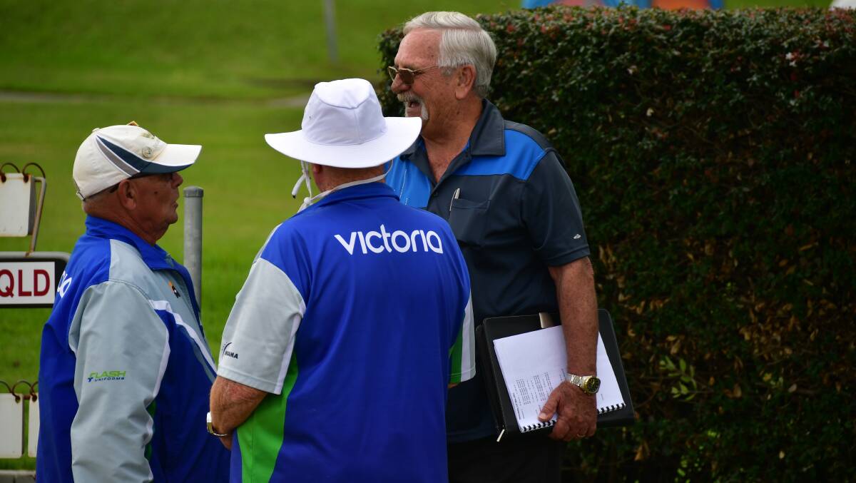 Keep going: Australian coach Jim Merrick (right) has a laugh with Victorian players at the blind bowlers national titles in Port Macquarie.