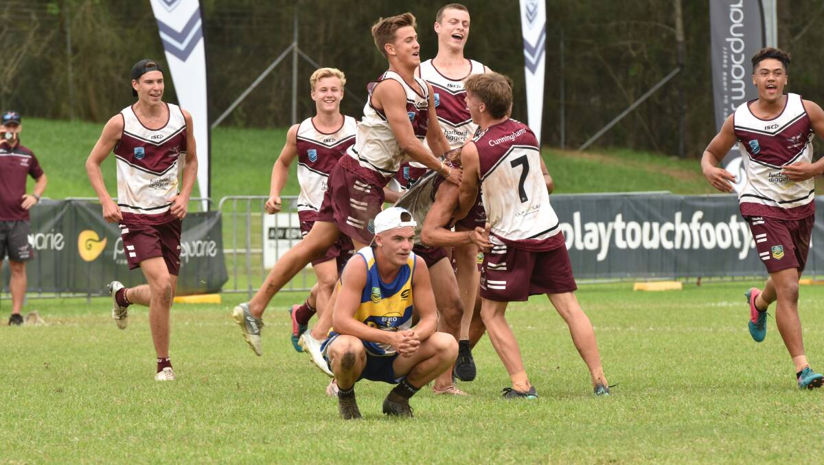 Happy days: Manly celebrate their NSW Junior State Cup under-18 boys northern conference title win over Beresfield on Sunday. Photo: Paul Jobber