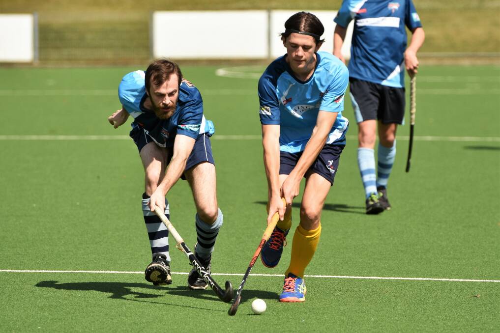 On the run: Cougars Vaughan Howarth and Blue Tongues Brad Paterson jostle for possession. Photo: Paul Jobber