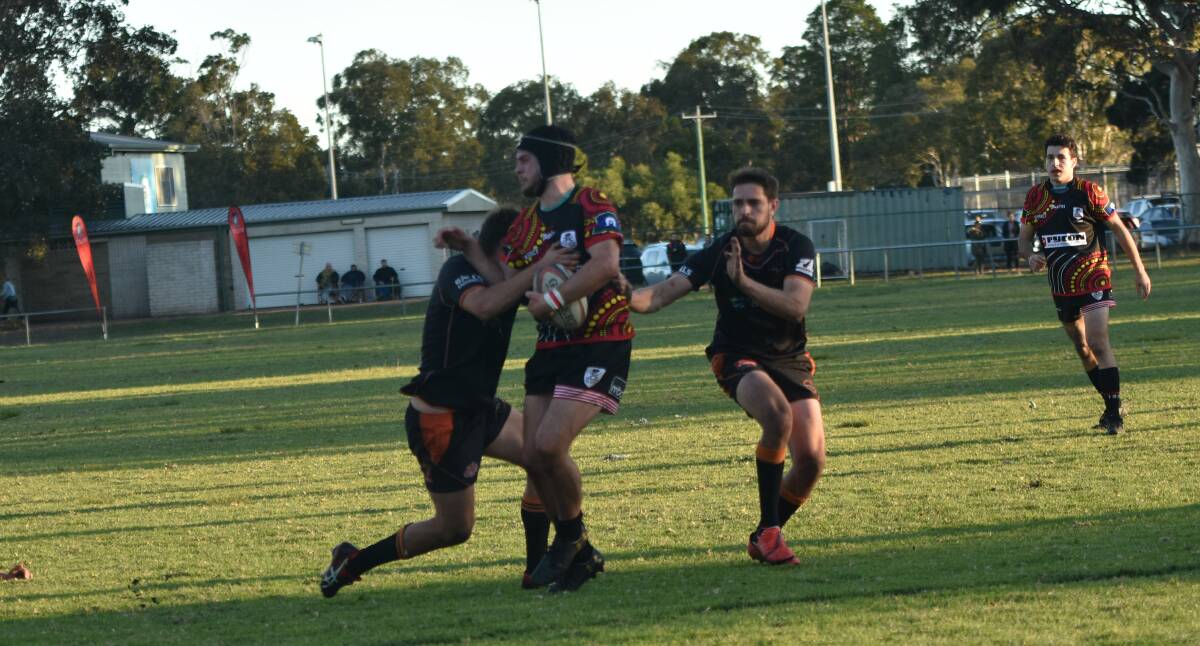 Hit and stick: Kaes Besseling pushes away from Kempsey's defence.