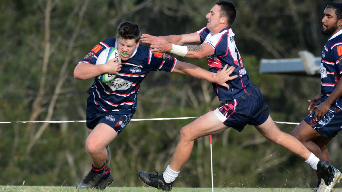 Off for the prize: Michael Smith evades the clutches of Dean Mills in Wauchope Thunder's 27-21 defeat to Manning River last weekend. Photo: Scott Calvin