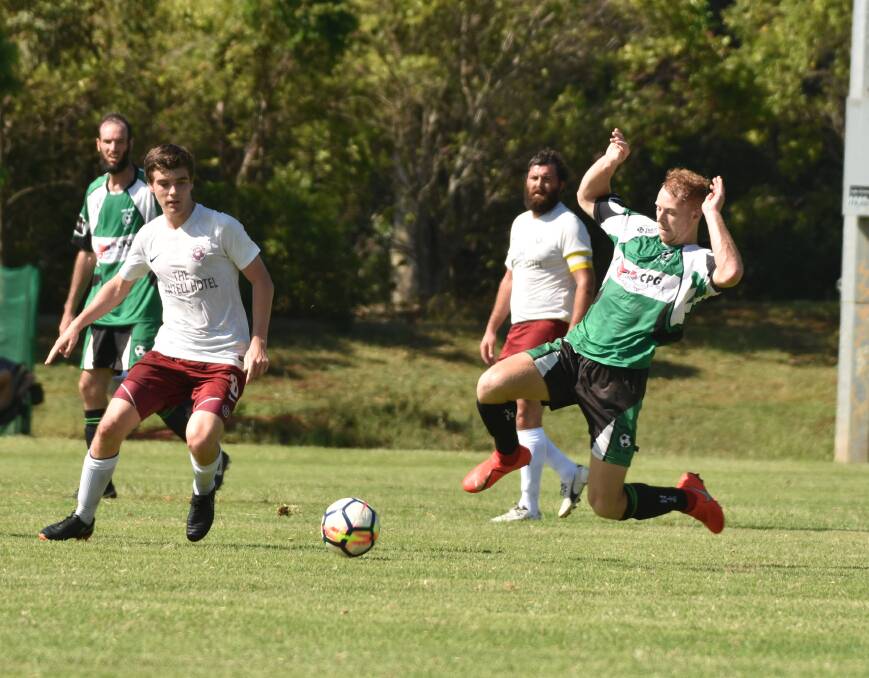 Get it: Josh Casey slides in to challenge for the ball against Boambee last Sunday. Photo: Paul Jobber