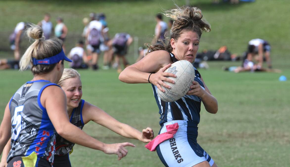 Out of reach: Shanene Matthews tries to evade the Newcastle defence in Coffs Harbour on Friday. Photo: Paul Jobber