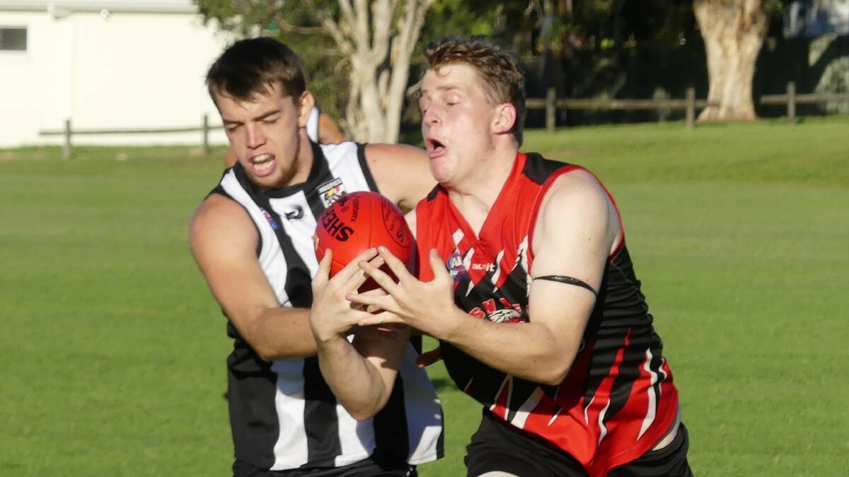 50-50 ball: Dylan Beasley challenges for possession in the Magpies round one win over Sawtell. Photo: supplied