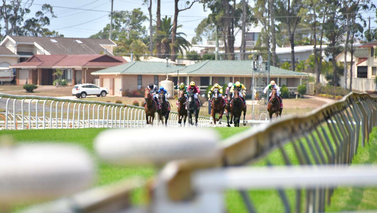 Show goes on: Horse racing was held at Port Macquarie in front of empty grandstands on Friday. Photo: Paul Jobber