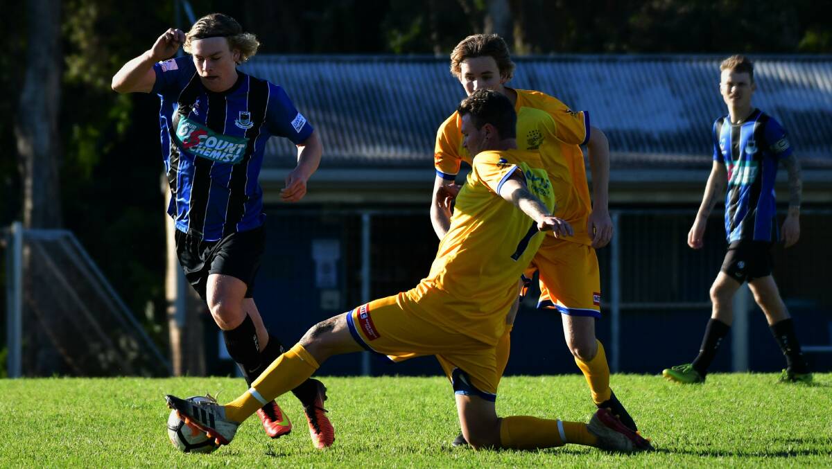 Stopped: Port Saints' Zane Haywood tries to evade the Macleay Valley defence during Saturday's 2-1 defeat. Photo: Paul Jobber