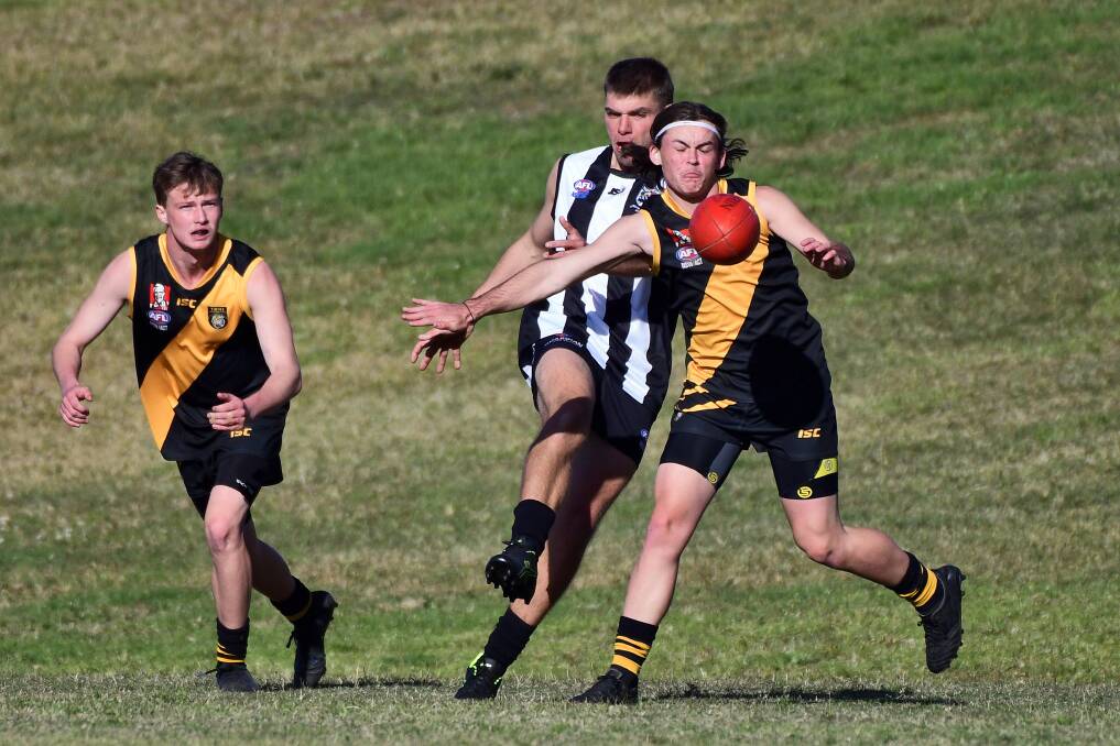 Clear it: Kye Taylor gets a kick away during the clash with Grafton. Photo: Matt Attard