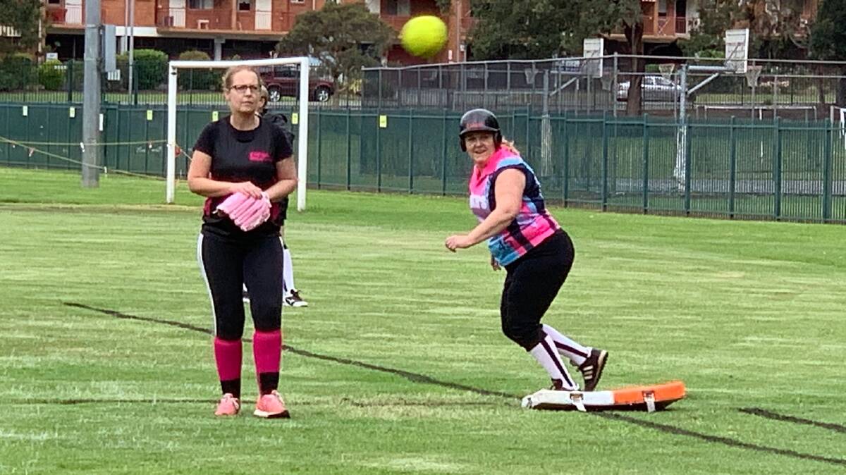 Focused: Warriors first-base player, Jo Bredin and Lakers runner Jo Walsh watch the ball. Photo: supplied