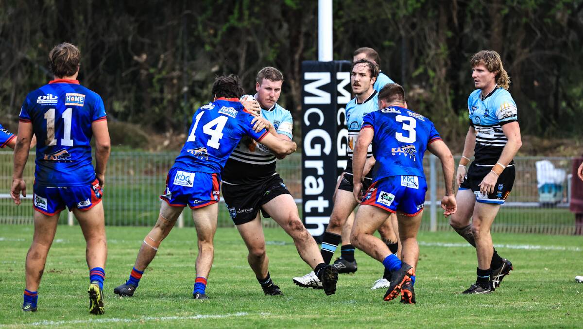 Port Macquarie Sharks forward Koby Smith takes the ball up last weekend. The match with Wauchope last weekend was one of the few to have so far been completed this season.